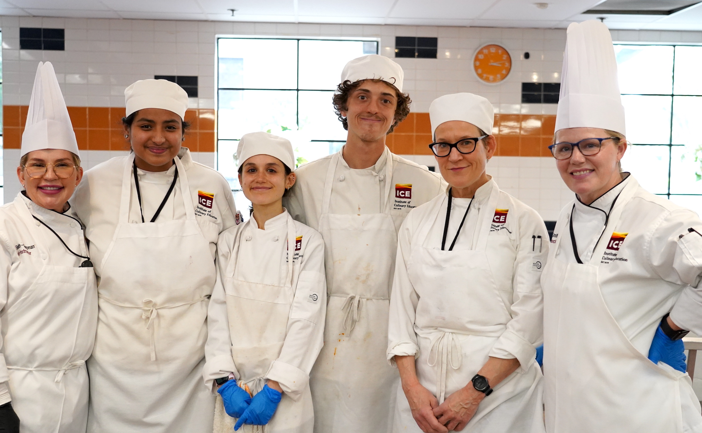 The Plant-Based Culinary Arts students and Chef-Instructors stand in a group, smiling