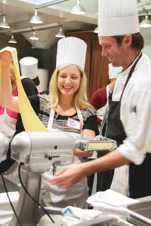 Guidance counselors cooking at an event at the Institute of Culinary Education