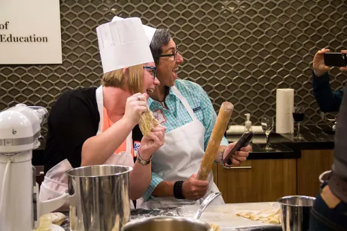Guidance counselors cooking at an event at the Institute of Culinary Education
