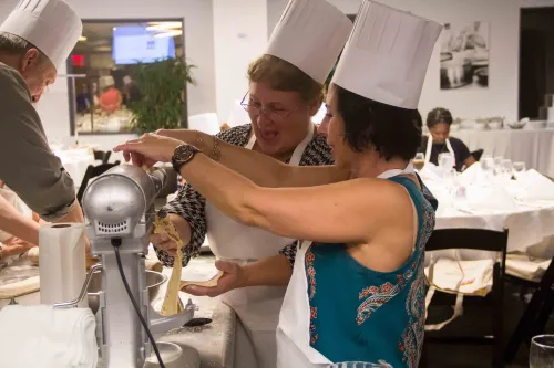 Guidance counselors cooking at an event at the Institute of Culinary Education