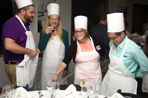 Guidance counselors cooking at an event at the Institute of Culinary Education