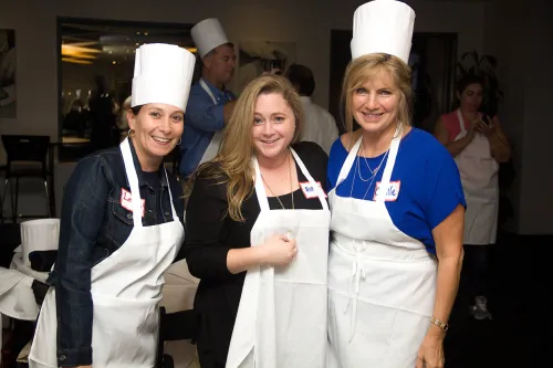 Guidance counselors cooking at an event at the Institute of Culinary Education