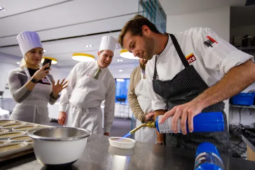 Guidance counselors cooking at an event at the Institute of Culinary Education