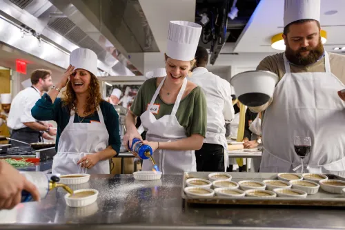 Guidance counselors cooking at an event at the Institute of Culinary Education