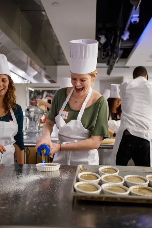 Guidance counselors cooking at an event at the Institute of Culinary Education