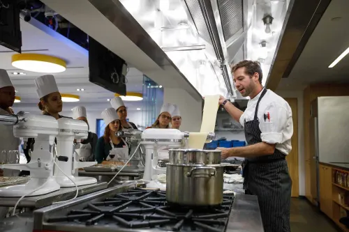 Guidance counselors cooking at an event at the Institute of Culinary Education