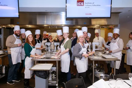 Guidance counselors cooking at an event at the Institute of Culinary Education