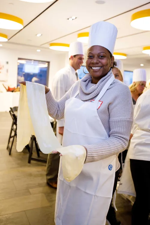 Guidance counselors cooking at an event at the Institute of Culinary Education