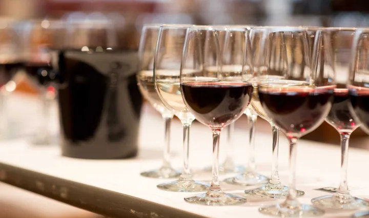 Wine glasses on a table with a spit bucket