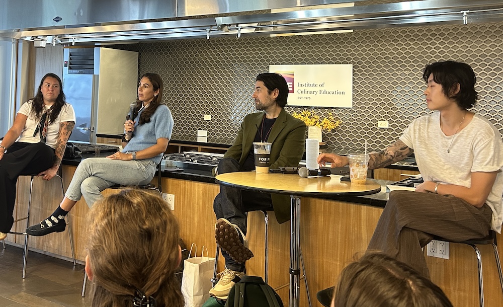 Four panelists sitting on a row in chairs