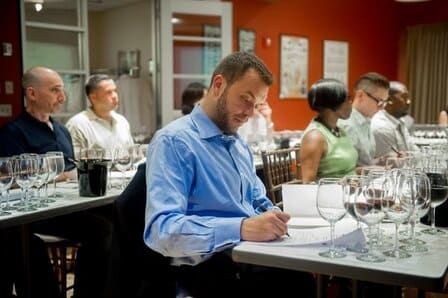 Wine Essentials student takes notes while wine tasting