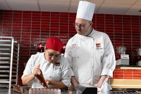 Chef Instructor Guiding Student in Chocolate Work