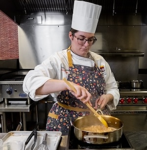Chef Sam reducing her chicken pan sauce.