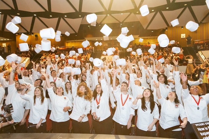 ICE graduation, students tossing toques into the air