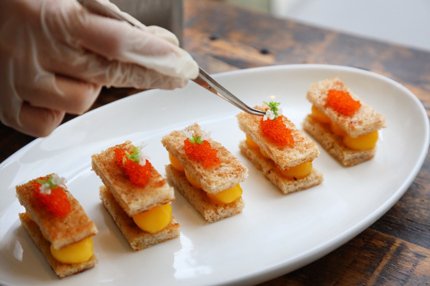 A series of canapes on a plate.