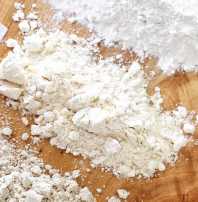Flour on a cutting board.