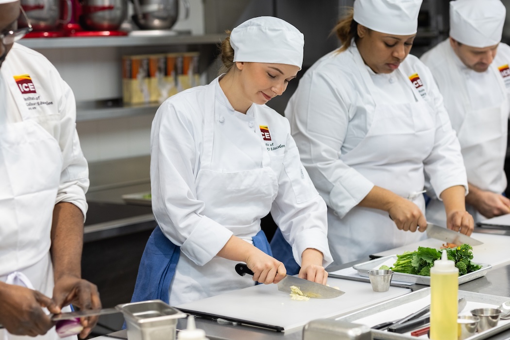 ICE students practicing knife skills in the kitchen.