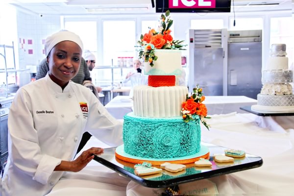 ICE student Genelle Beaton in front of her award winning cake. 