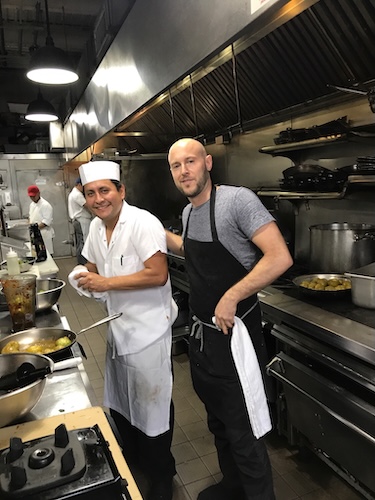 ICE alum James Durazzo in a kitchen with a cook. 