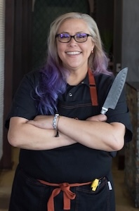 ICE alum Tanya Pustelnik holding a knife.