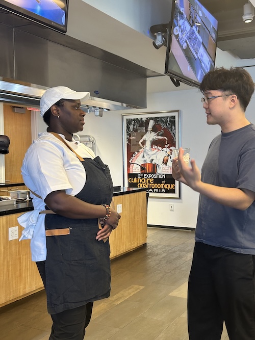 ICE alumna Chef Rose Noel shares industry insights and culinary tips with a student ahead of her campus live demo.