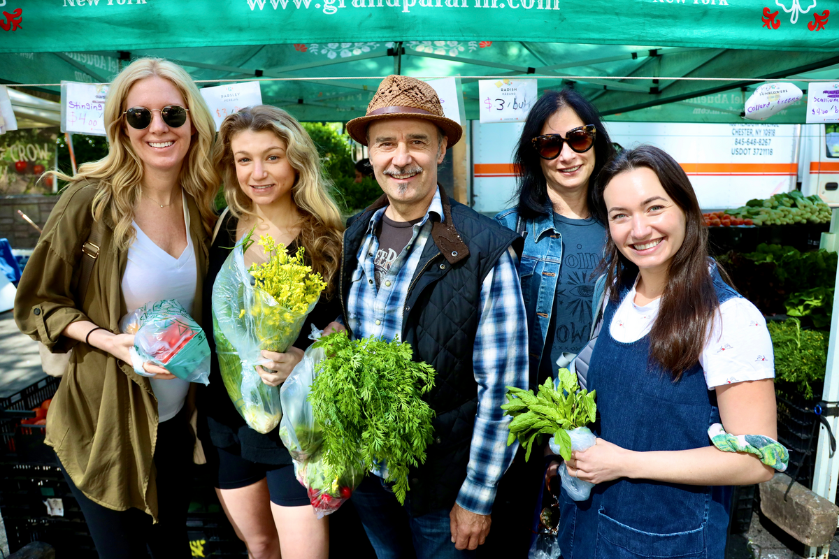 Chef Herve with ICE students holding vegetables