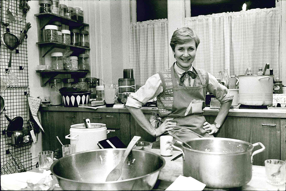Annemarie Colbin Ph.D. smiles in a kitchen.