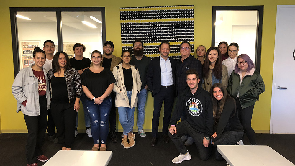 Bret poses with Restaurant & Culinary Management students after a guest lecture at ICE.