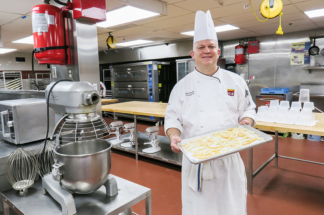 Chef Herve holds a tray at ICE's Los Angeles campus.