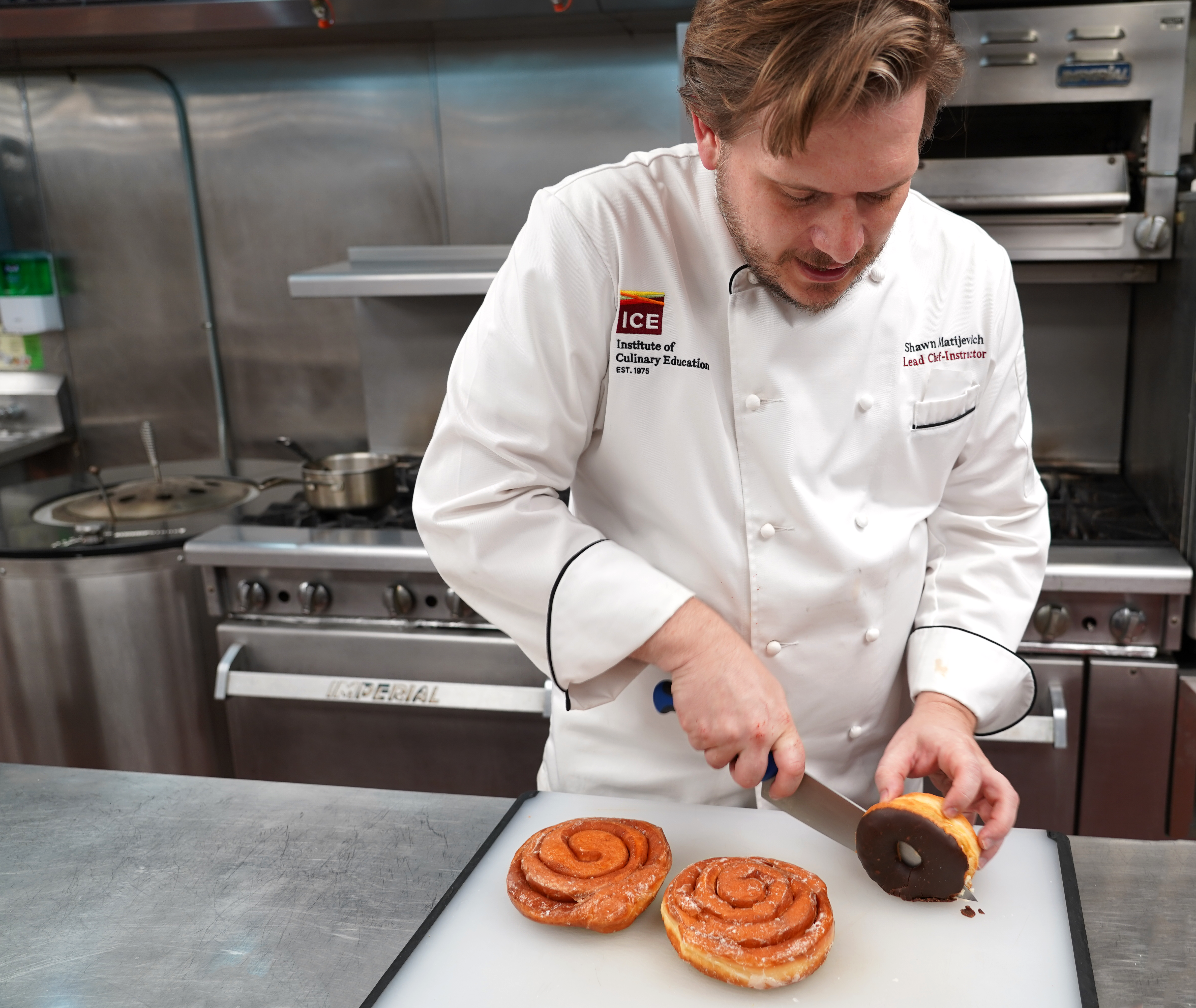 Chef Shawn cutting a donut on a white cutting board
