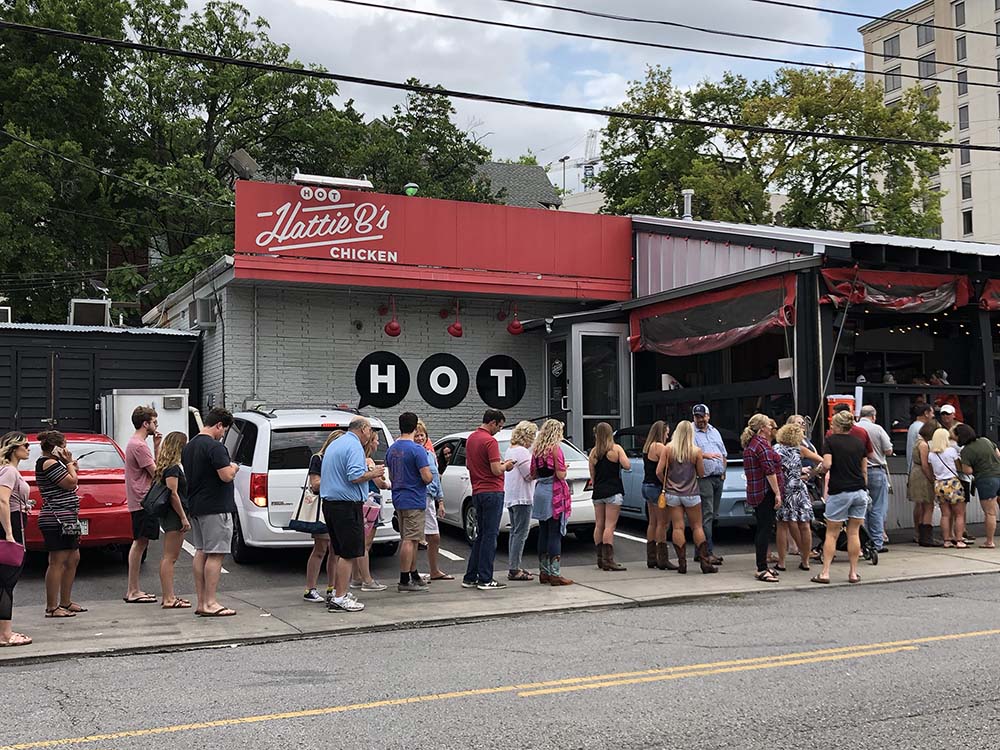 People wait in line for authentic Nashville hot chicken at the original Hattie B's.