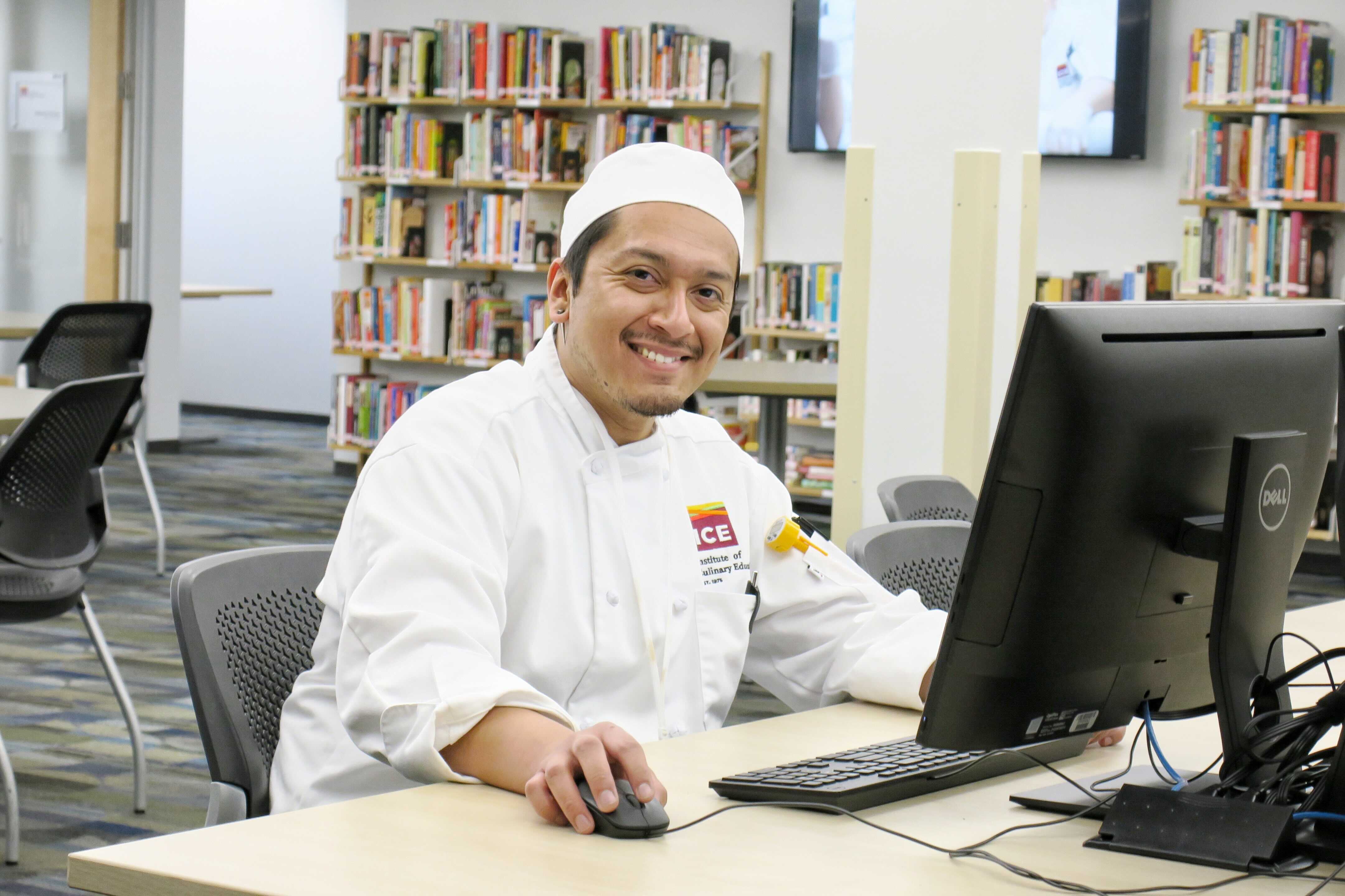 A student studies in the learning resource center at ICE's Los Angeles campus
