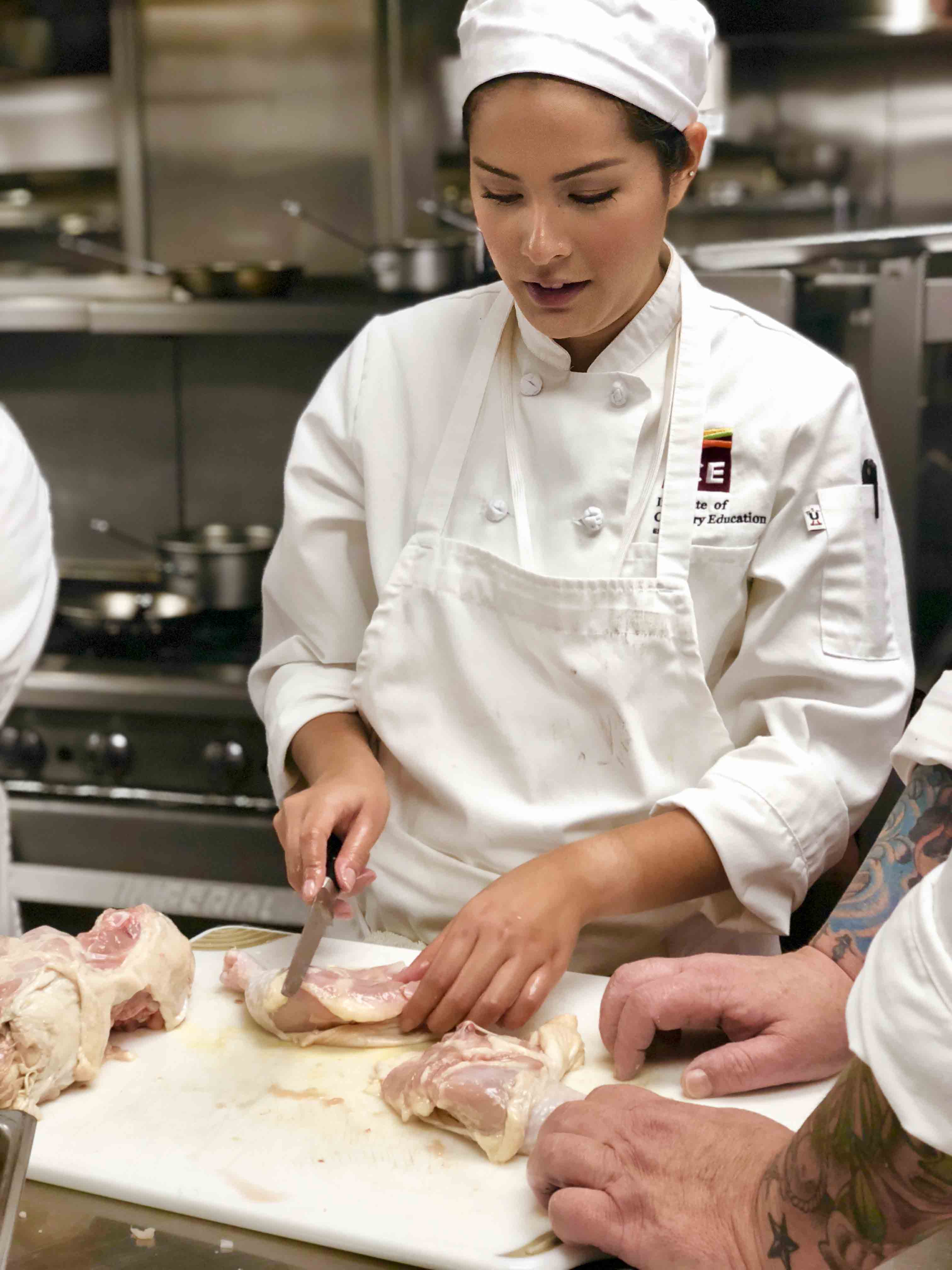 Maki Yazawa prepares poultry in an ICE Culinary Arts class.