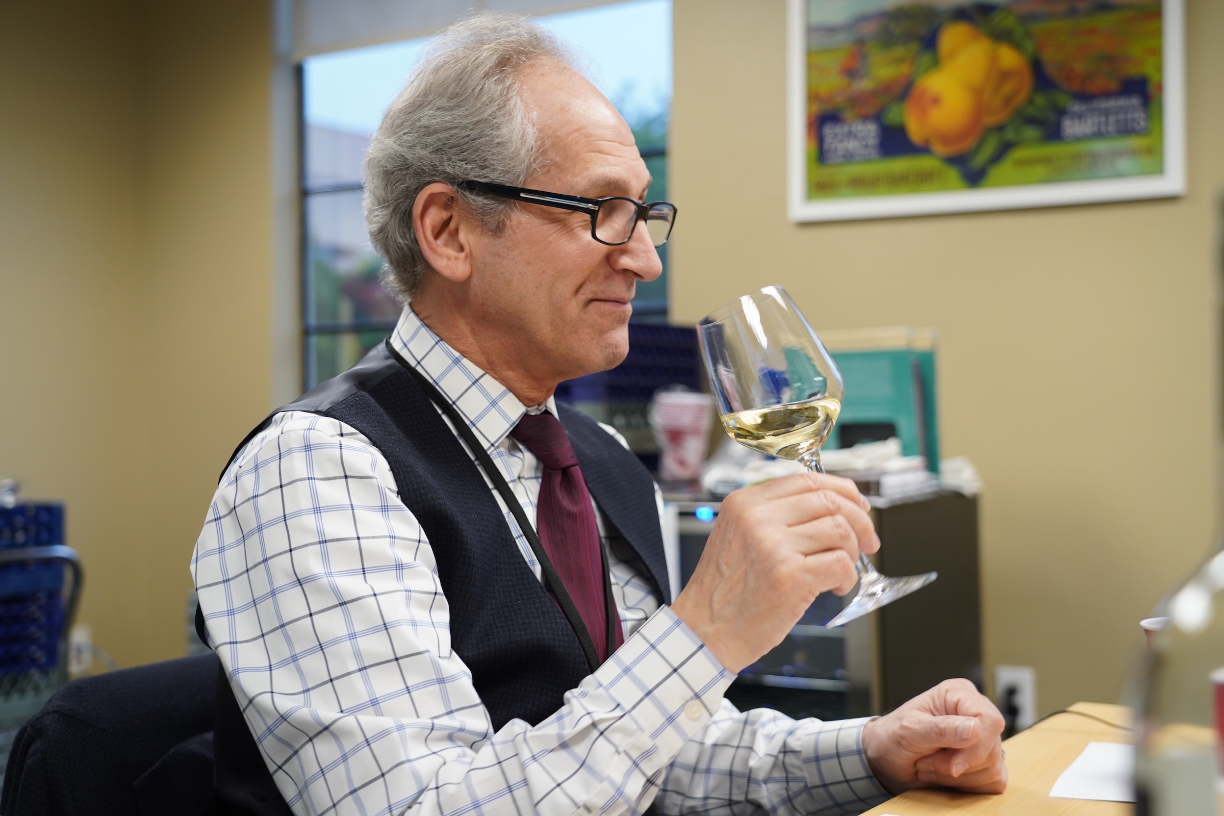 ICE LA's Lead Instructor of Wine Studies Paul Sherman smells of glass of white wine for the ICE course on how to become a sommelier