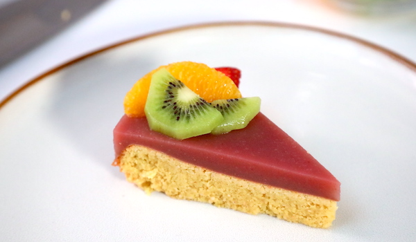 A pie of colorful fruit pie sits on a white plate for plant-based culinary school online