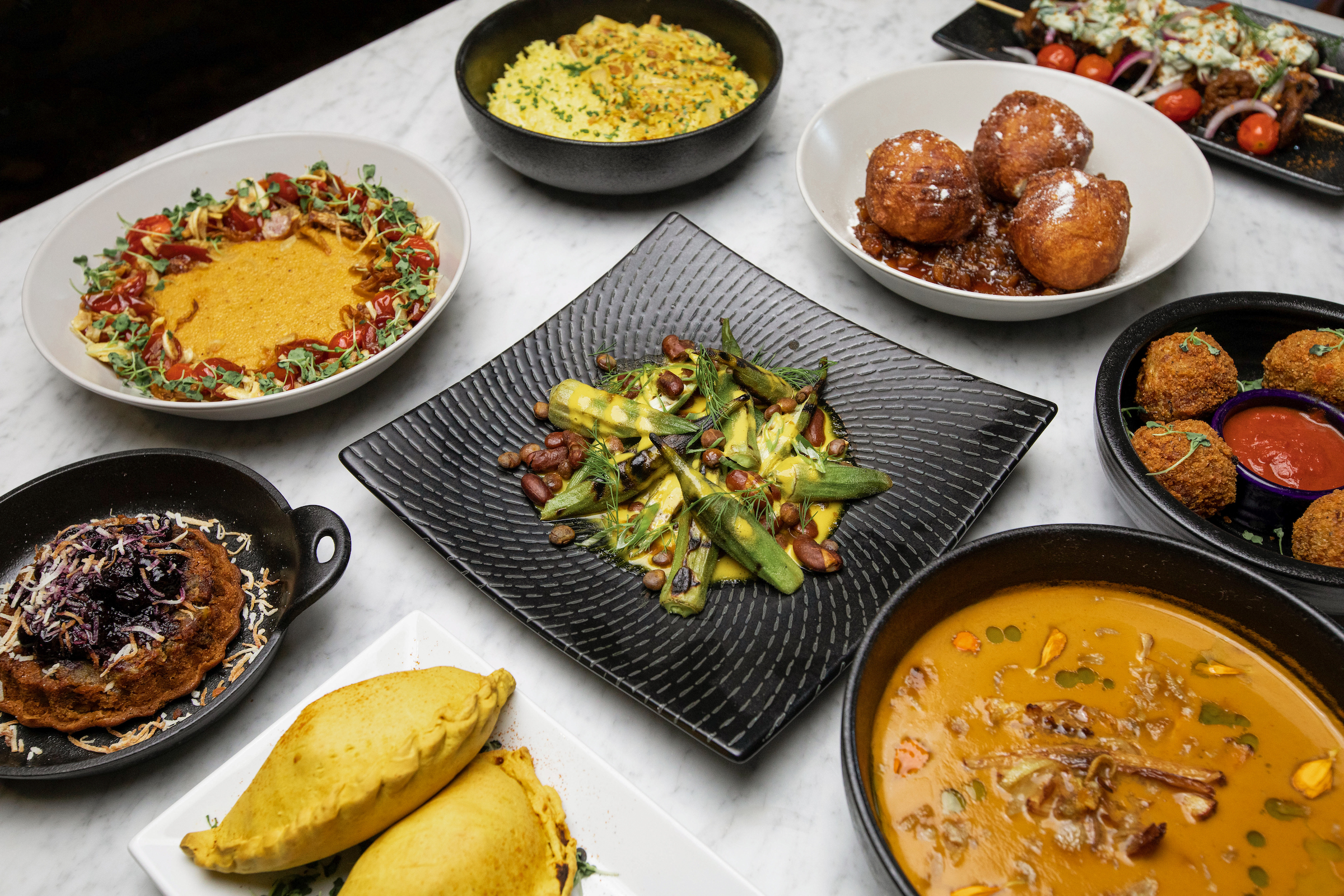 An assortment of dishes from Ubuntu sit on a white tablecloth