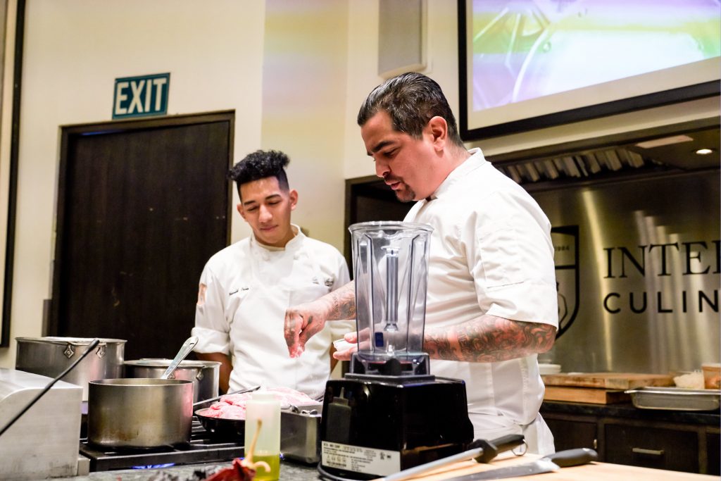 A student assists Aaron Sanchez during a demo at ICC