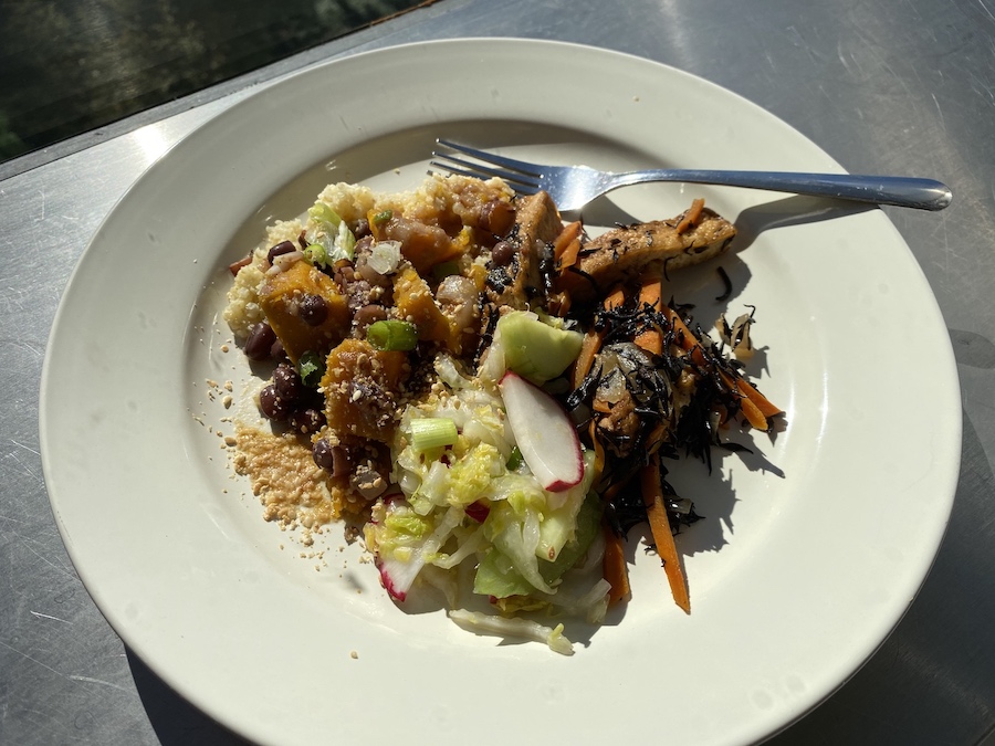 A plant-based meal of tofu, squash, beans and cucumber salad