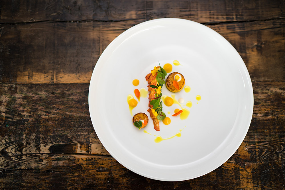 Lobster tail, butternut squash discs, curry oil and marigold