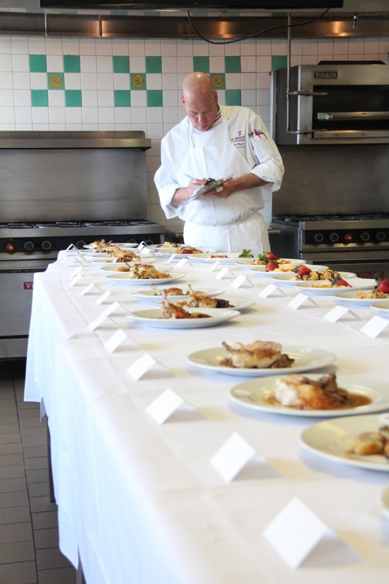 Chef Ted Siegel judges the poulet chasseur and crêpes sucrées prepared by the C-CAP competitors.