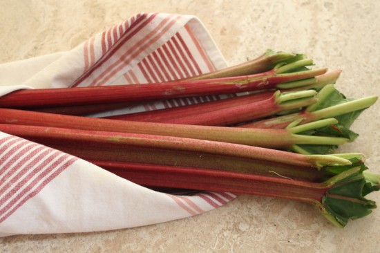Washed rhubarb wrapped in a kitchen towel to dry before using in a pie