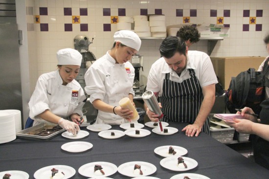 ICE students help winner Bill Corbett plate his vegan German chocolate cake.