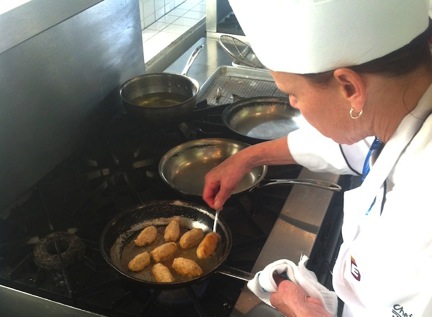 Chef Anna Sporer demonstrating how to get the perfect crust on her crab cake quinelles.