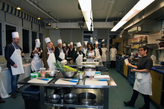 Kitchen B guests learning about their cooking assignment.