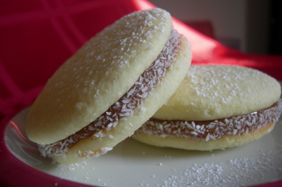 Alfajores filled with dulche de leche and sprinkled with shredded coconut
