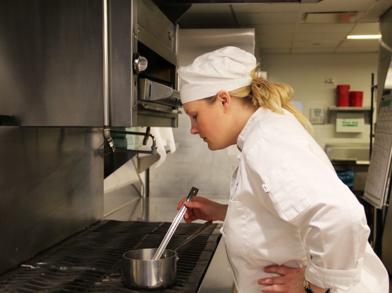 Kelly Newsome cooking after enrolling in culinary school