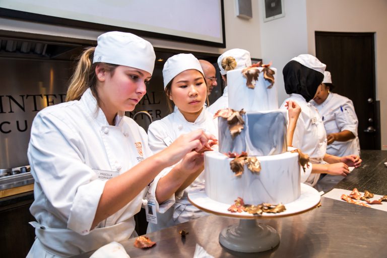 ICC students work on a wedding cake