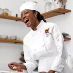 ICE alumna Onika Brown smiles while taking a bite of creme brulee