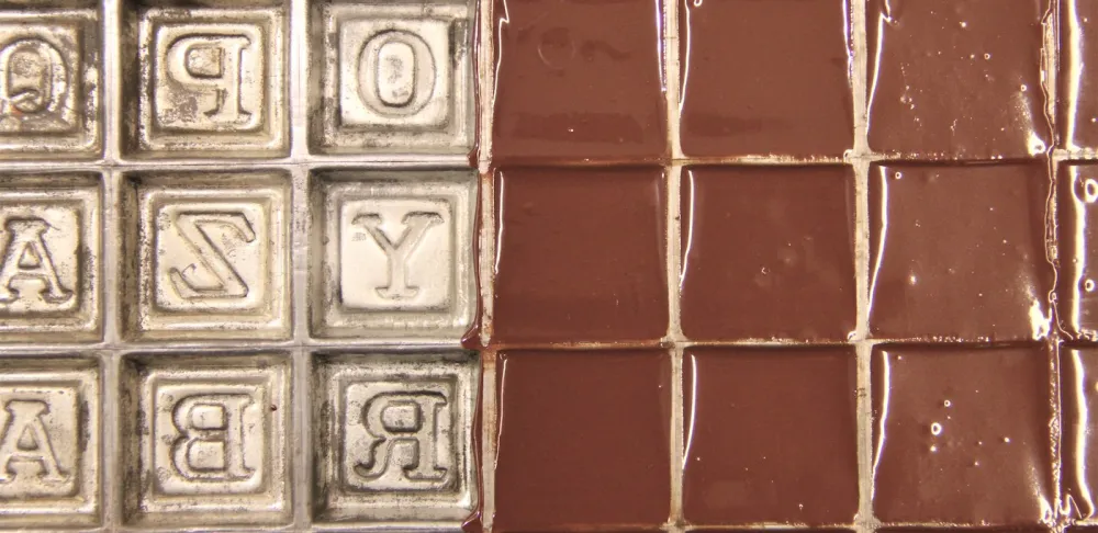 casting chocolate in an alphabet block mold