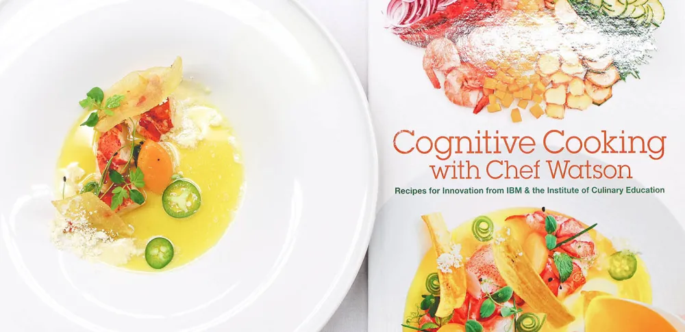 Cognitive Cooking with Chef Watson cookbook and a dish prepared from a recipe in the cookbook
